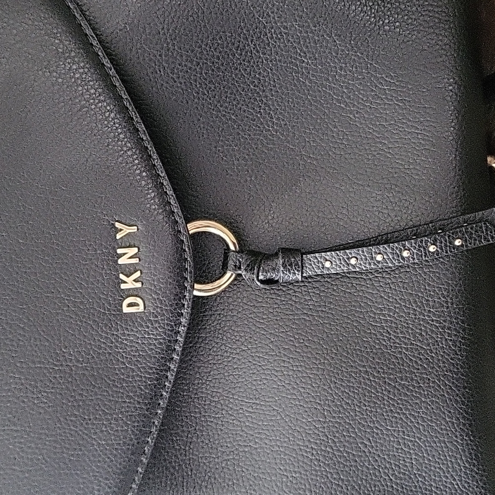 DKNY pebble leather backpack handbag with gold hardware.